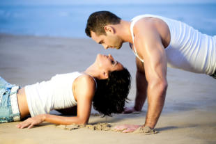 Young couple lying down on beach