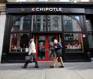 NEW YORK CITY - OCTOBER 22, 2015: Pedestrians walk past a Chipotle Mexican fast food restaurant. Chipotle Mexican Grill, Inc. is a chain of restaurants.